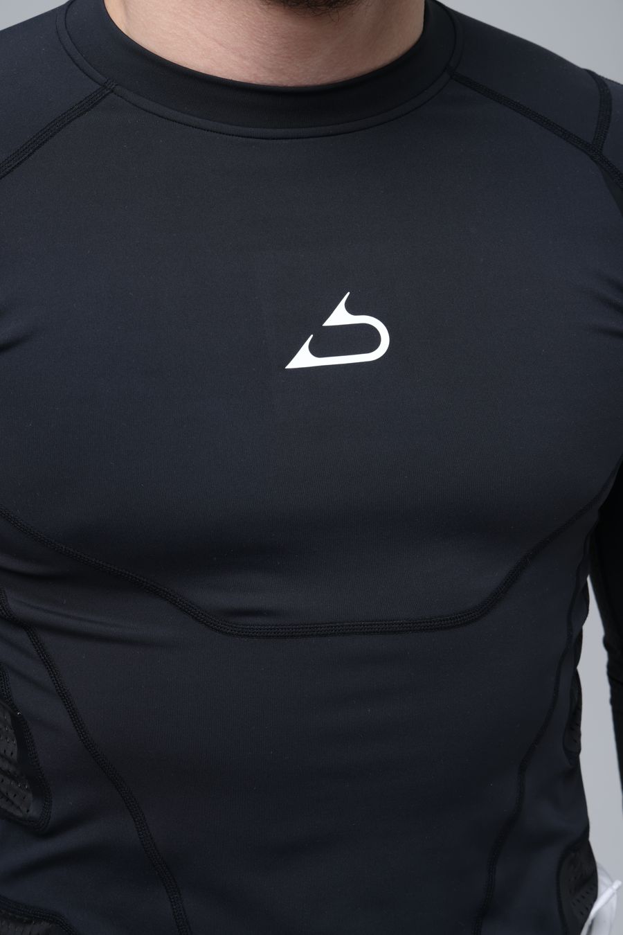 Abjari logo on the chest of a black compression top