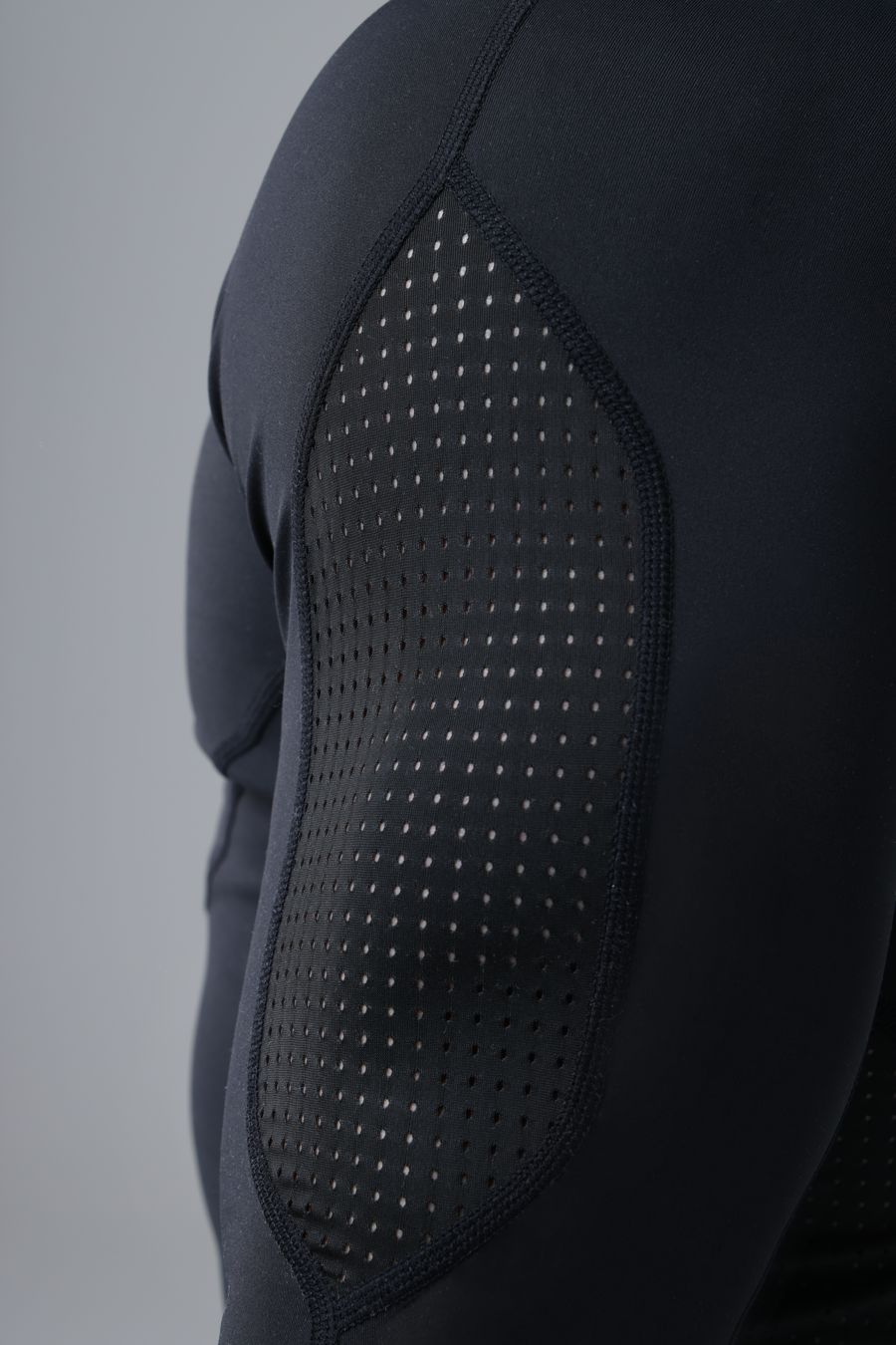 Perforated mesh panel along the side of the rash guard