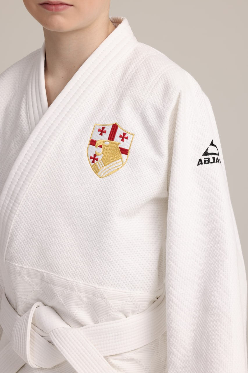 White judogi with an embroidered team crest